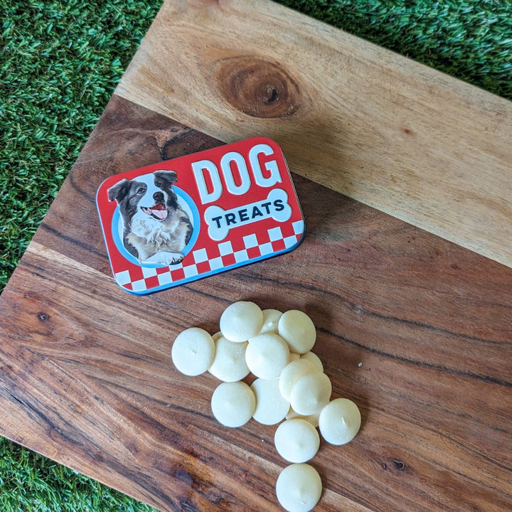 Retro dog treats tin and yogurt drops displayed on wooden board Bonza Dog Treats