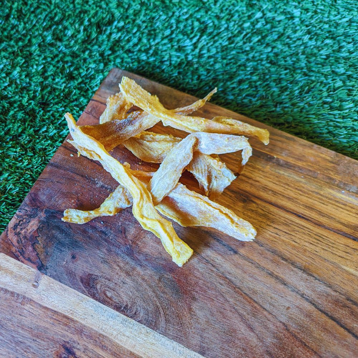 SHark jerky sticks skinless on wooden board placed on grass Bonza Dog Treats